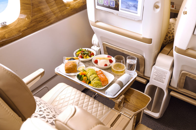 a tray of food on a table in an airplane