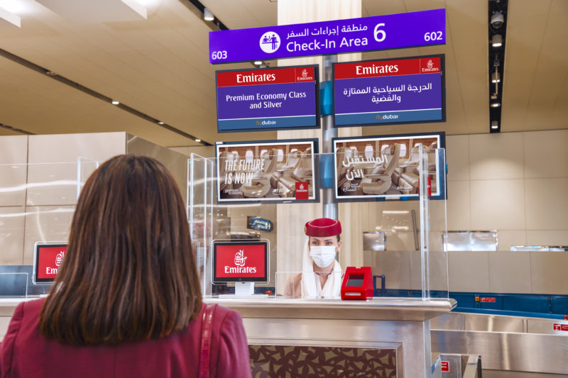 a woman standing behind a counter in an airport