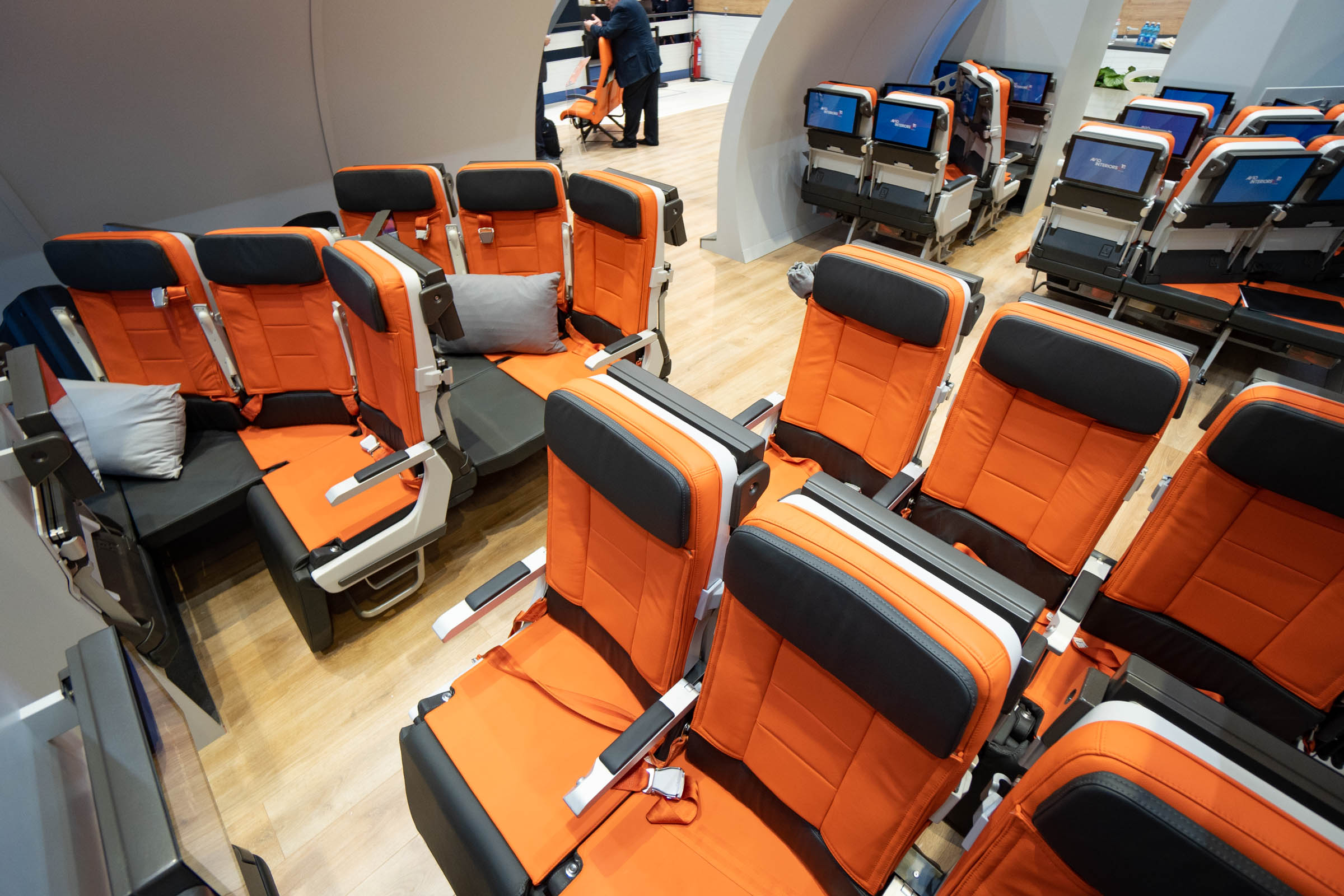 an airplane seat with orange seats
