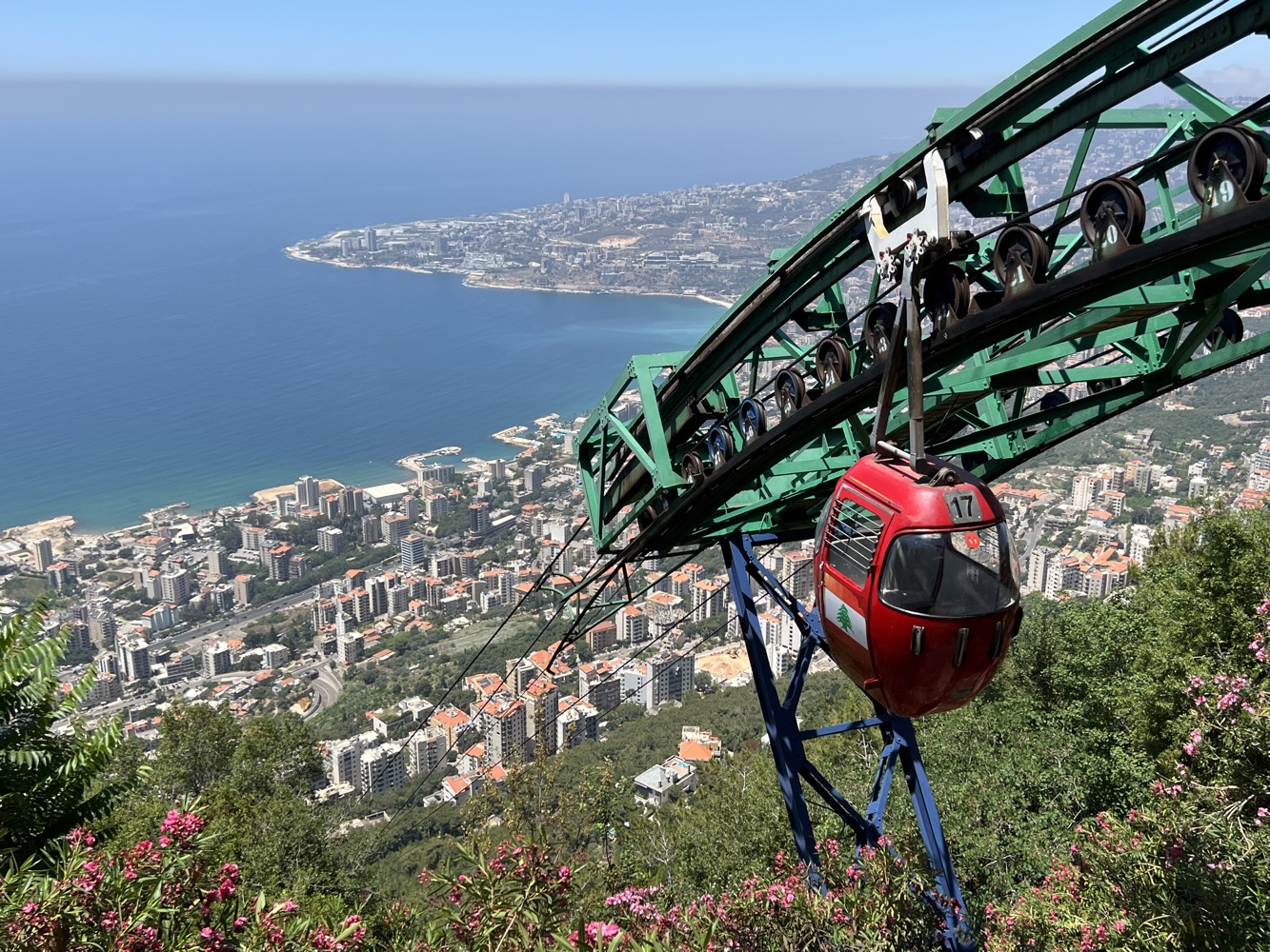 a cable car going up a hill above a city