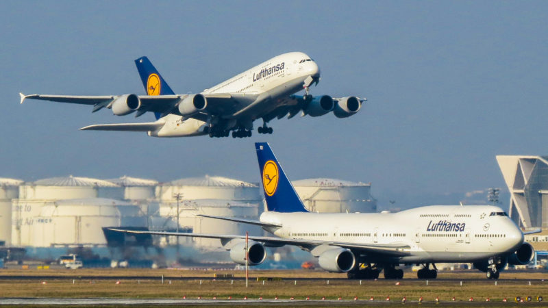 two airplanes taking off from a runway