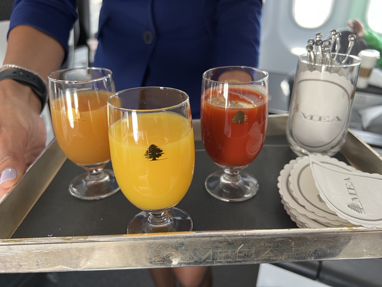 a tray of drinks on a plane