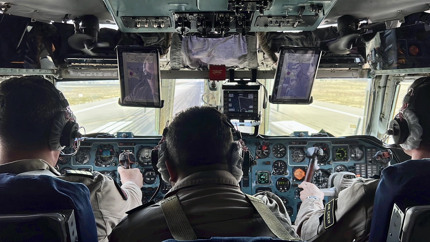 a group of people in a cockpit of an airplane