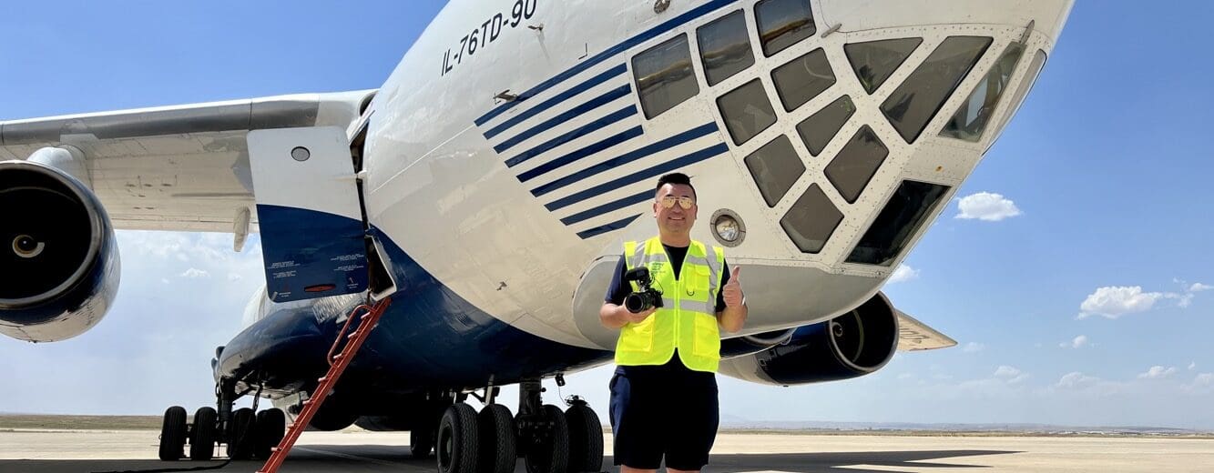 a man standing in front of a plane