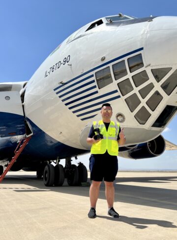 a man standing in front of a plane