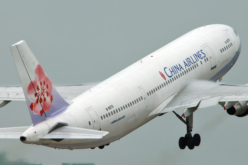 a white airplane with red and blue logo