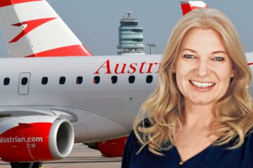 a woman smiling in front of a plane