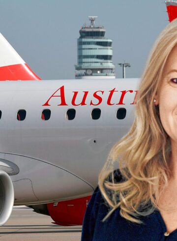 a woman smiling in front of a plane