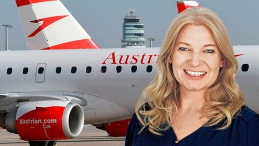 a woman smiling in front of a plane