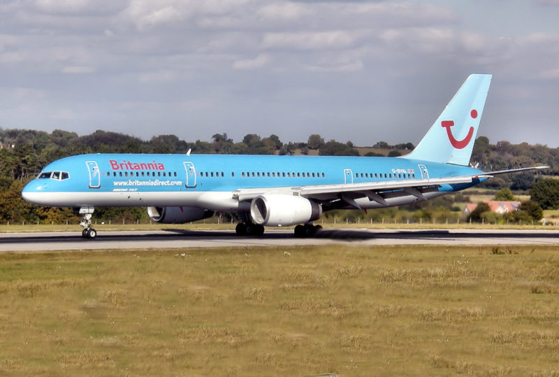 a blue airplane on a runway