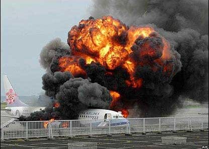 an airplane on fire with black smoke