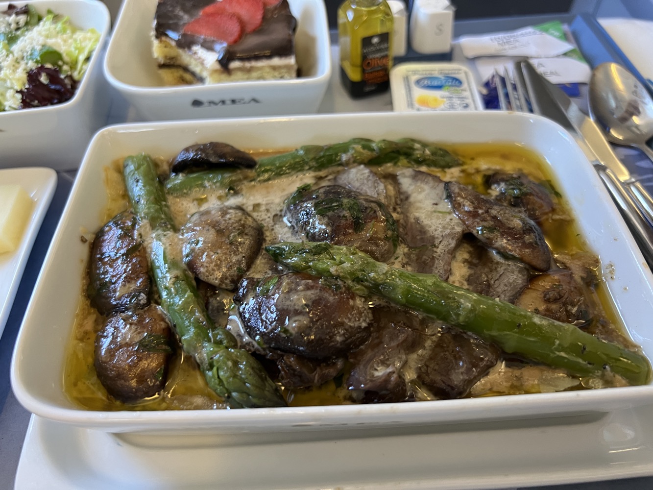 a dish of food with asparagus and mushrooms