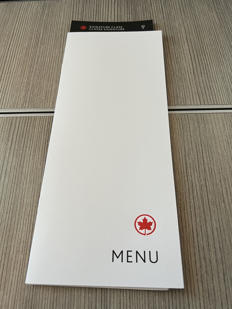 a white rectangular menu on a wood surface