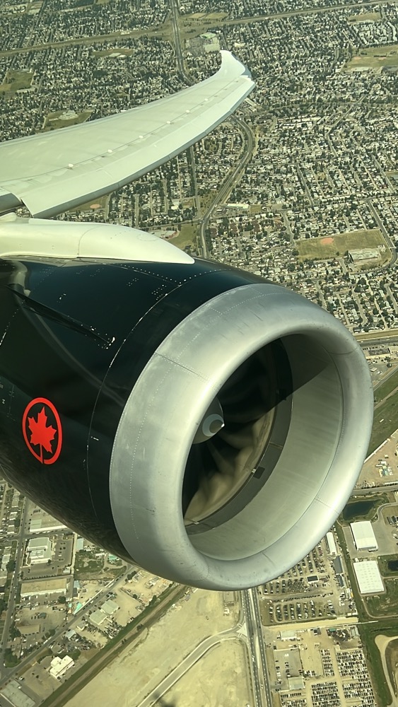 a plane engine with a city in the background