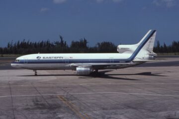 a white and blue airplane on a runway