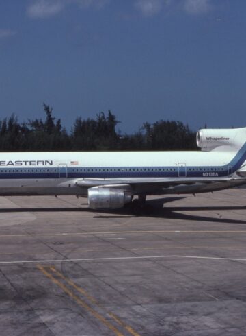 a white and blue airplane on a runway