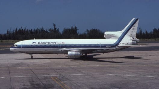 a white and blue airplane on a runway