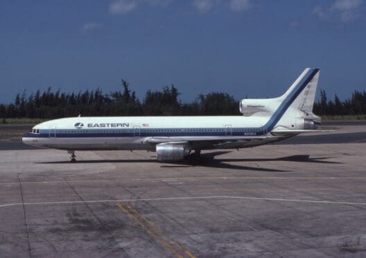 a white and blue airplane on a runway