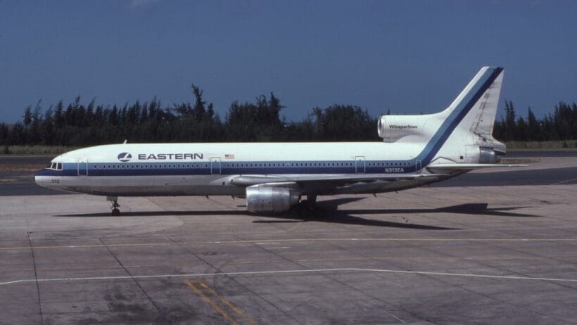 a white and blue airplane on a runway