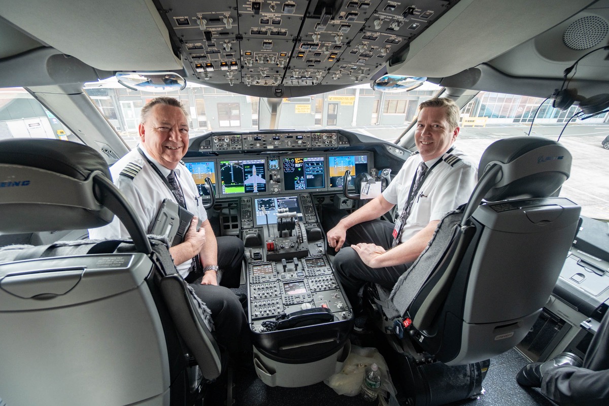 two men in the cockpit of an airplane