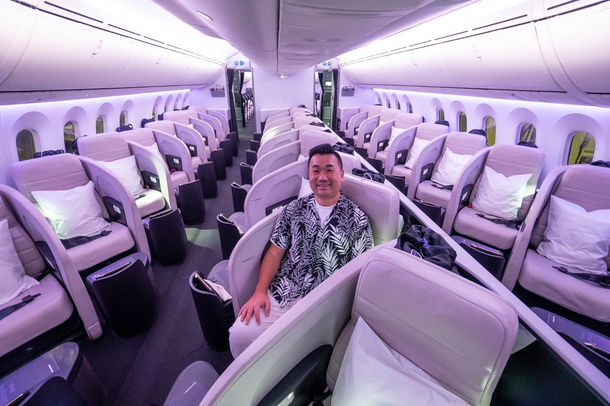 a man sitting in a chair in an airplane