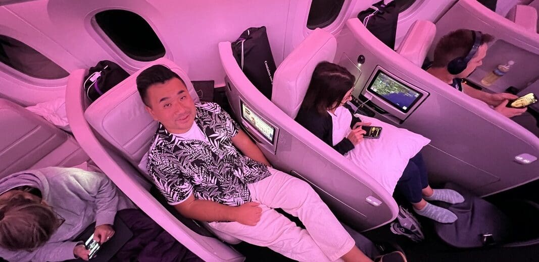 a group of people sitting in chairs on an airplane