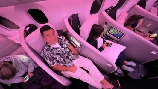 a group of people sitting in chairs on an airplane