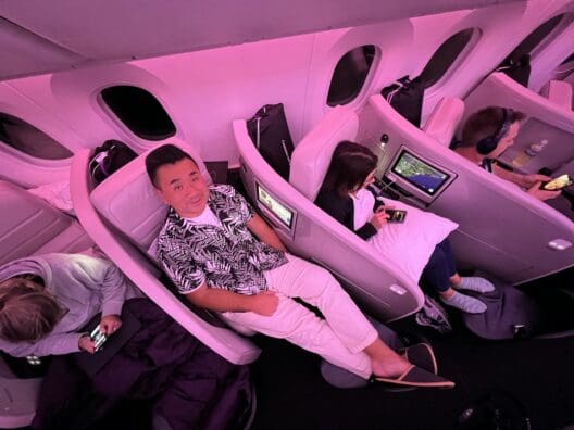 a group of people sitting in chairs on an airplane