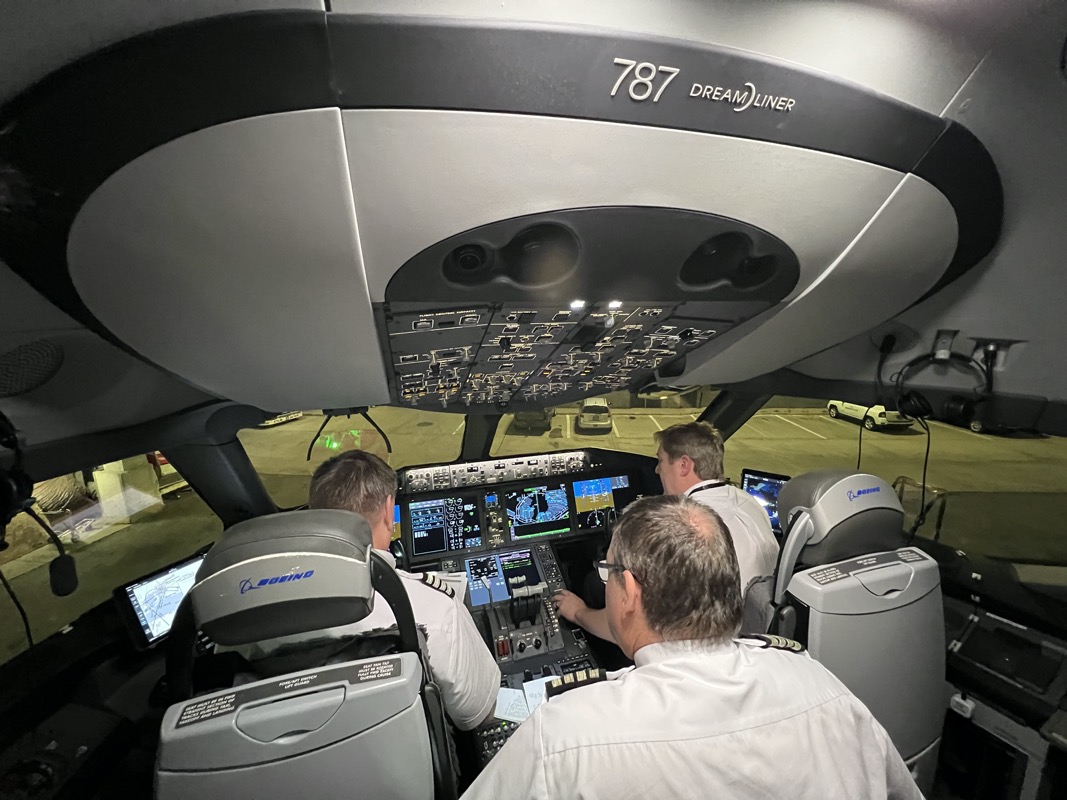 a group of men in a cockpit of an airplane