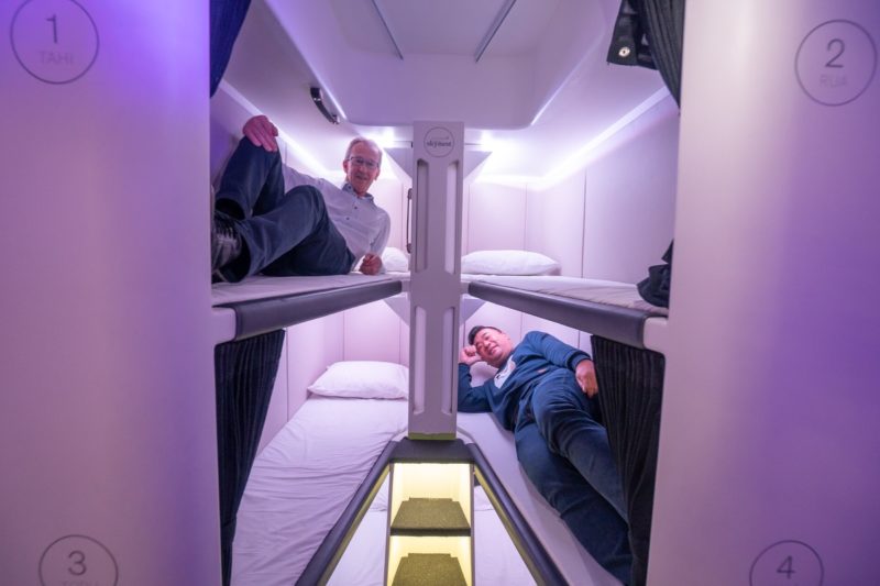 two men lying on bunk beds in a room