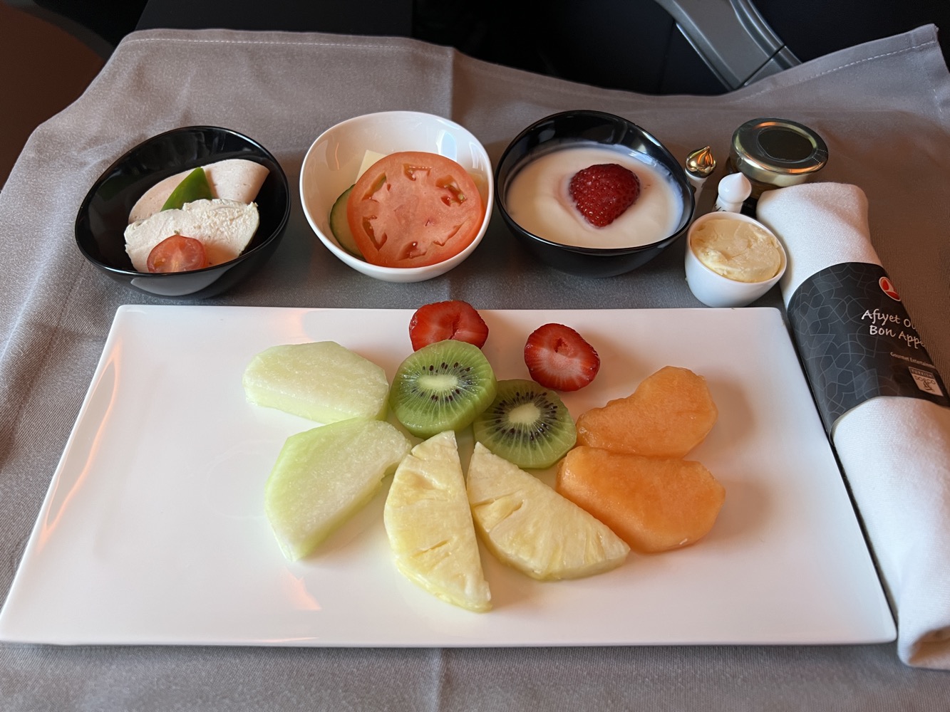 a plate of fruit and yogurt on a table