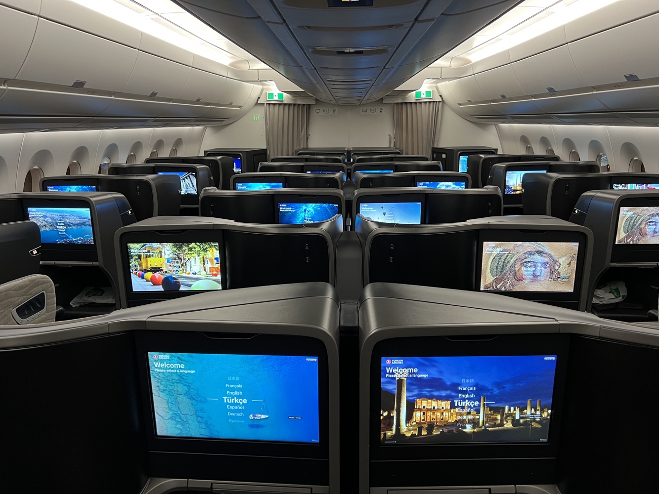 a row of tvs in an airplane