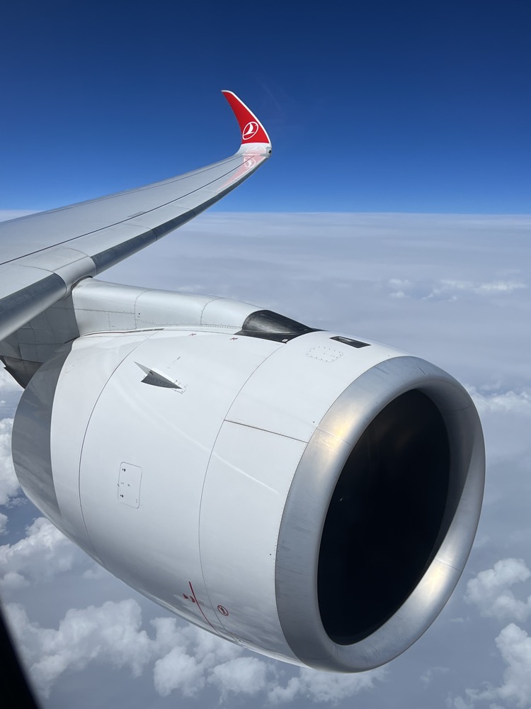 an airplane wing with a red and white logo