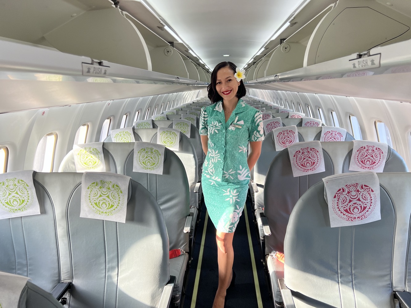 a woman in a dress standing in an airplane
