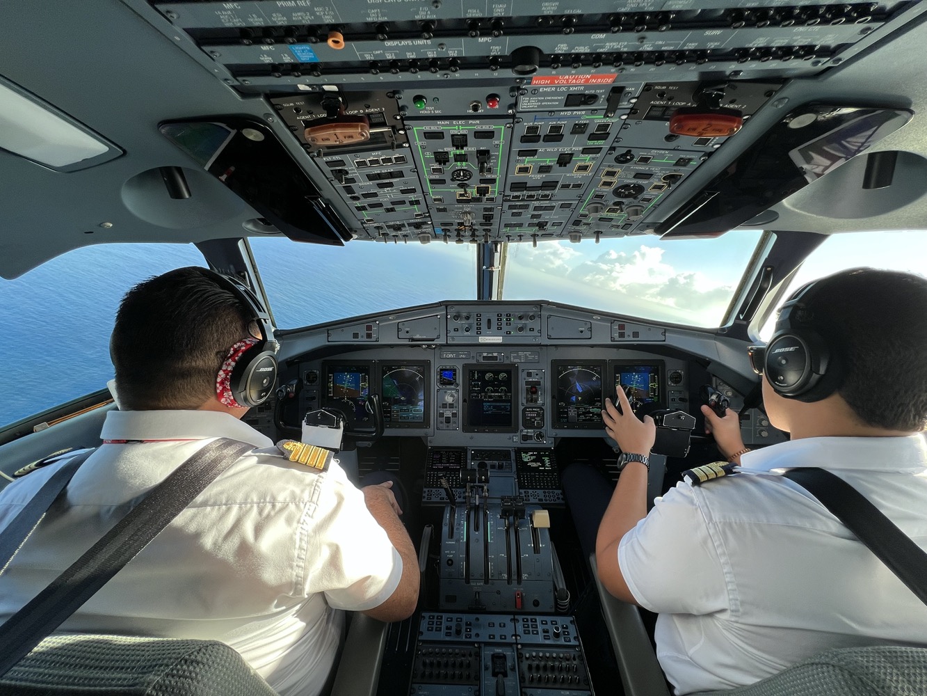 two men in the cockpit of an airplane