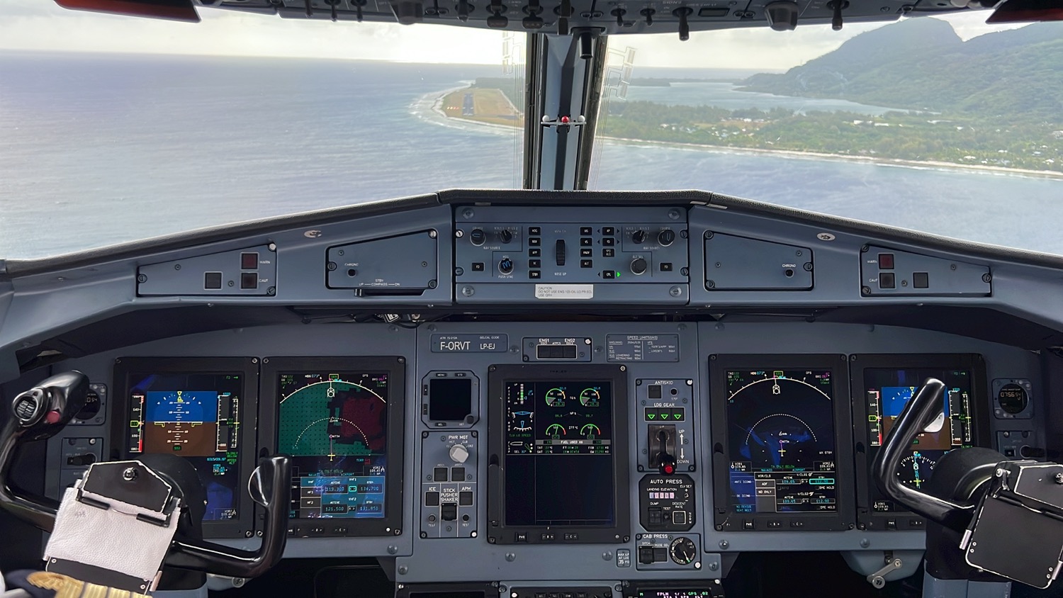 the cockpit of an airplane with a view of land and water