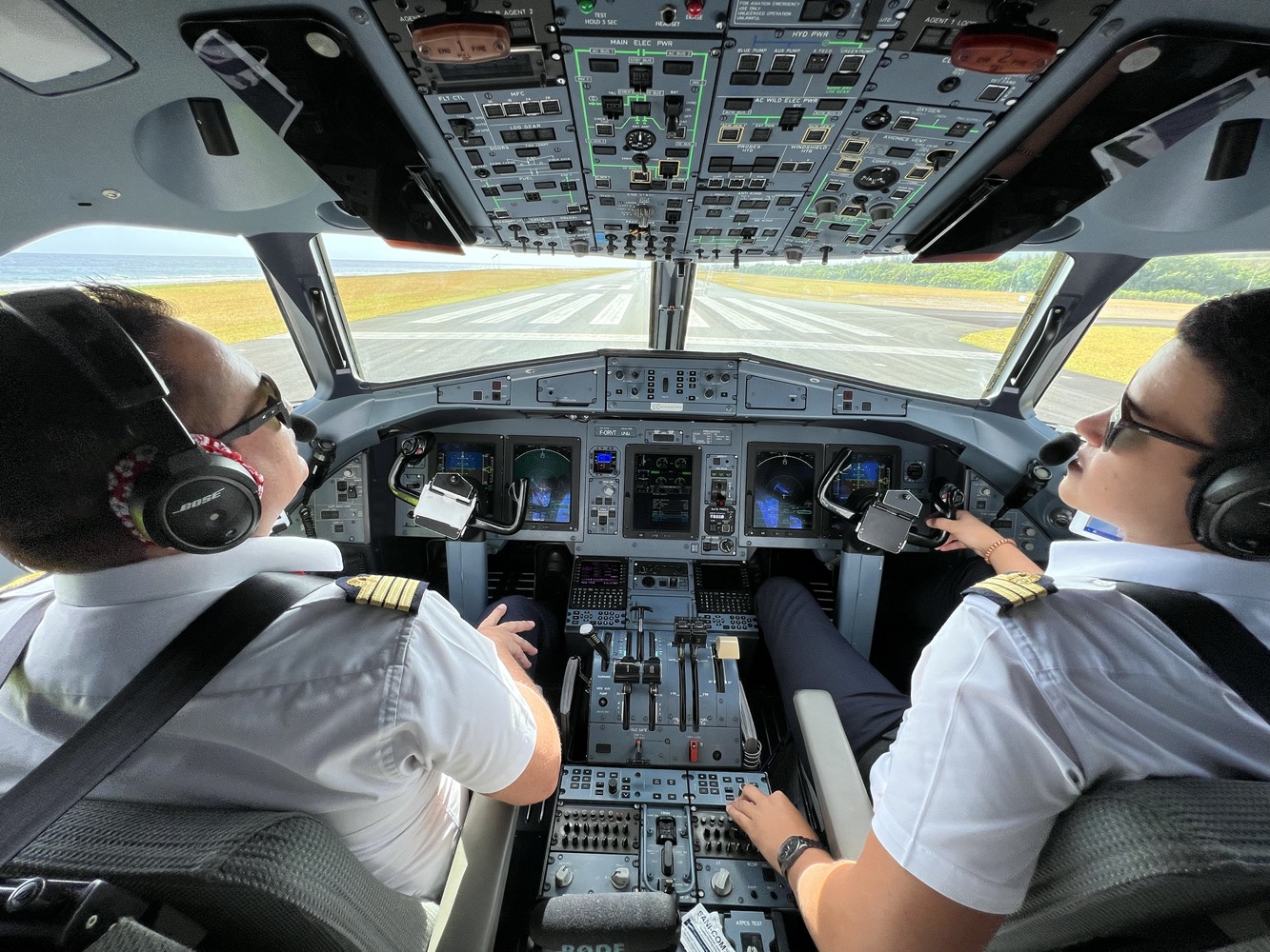two people in the cockpit of an airplane