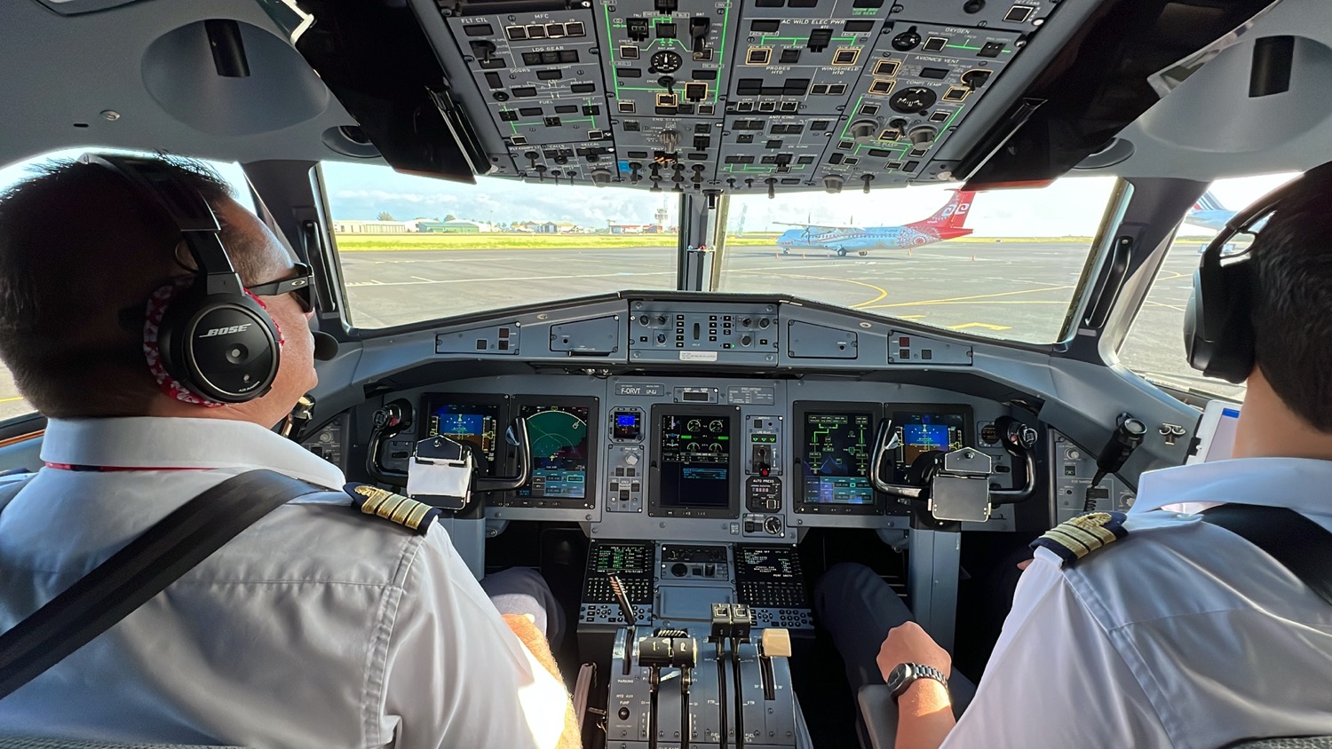 two men in a cockpit of an airplane