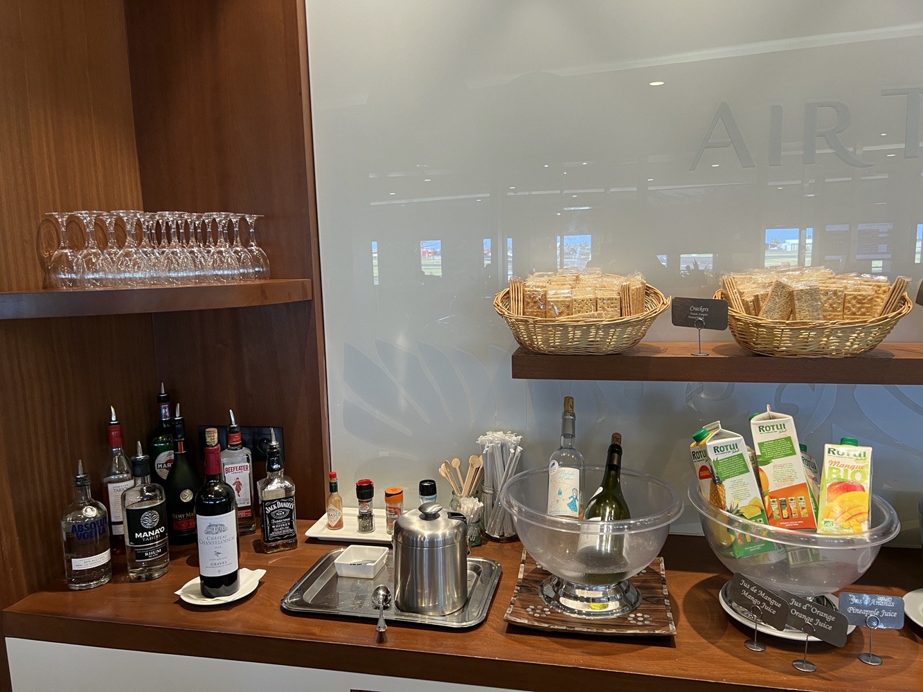 a bar with bottles and glasses on shelves