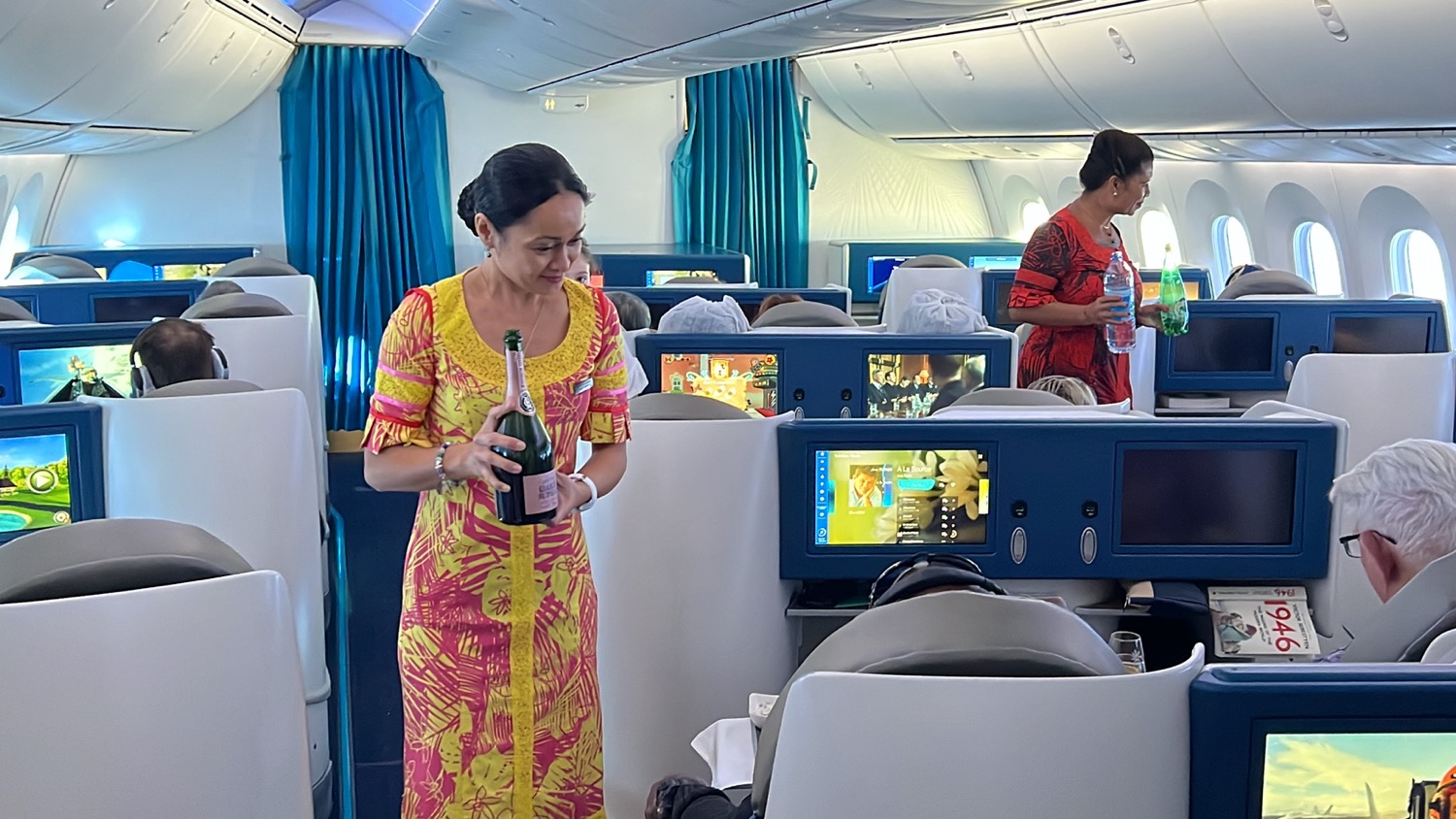 a woman holding a bottle in an airplane