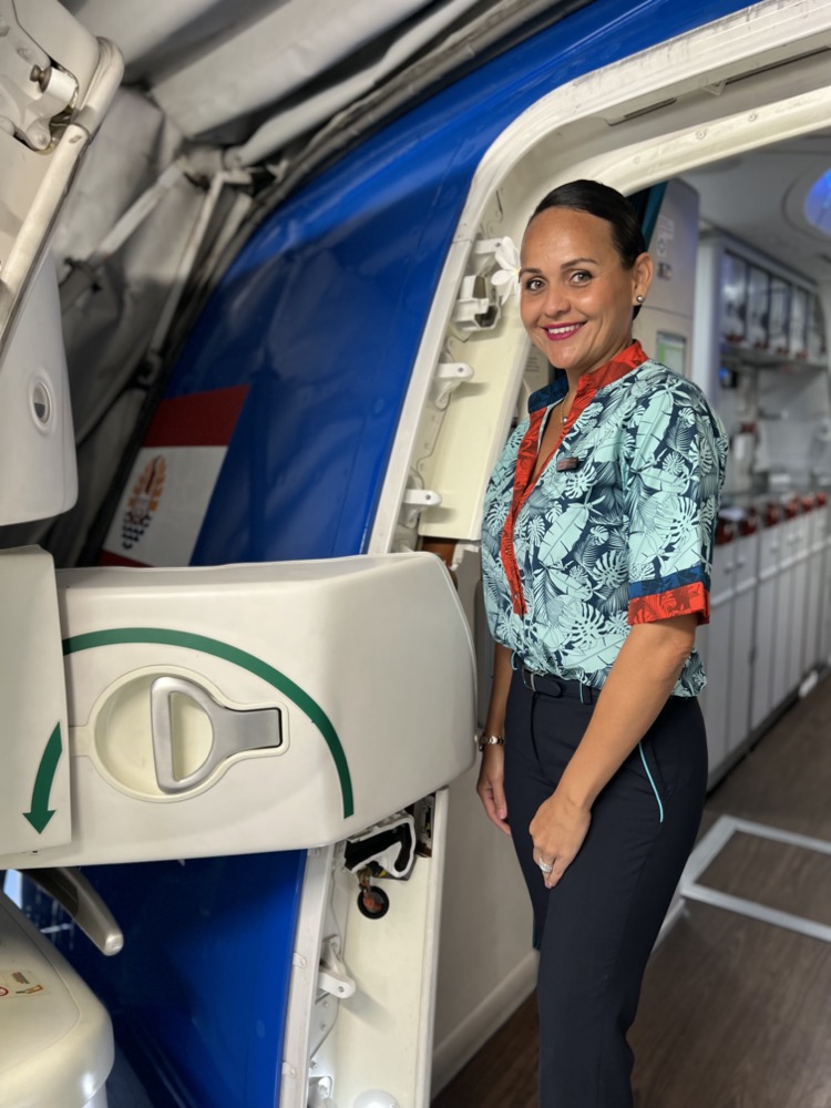 a woman standing in front of an airplane door