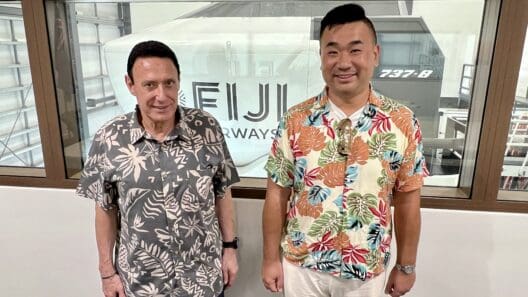 two men standing in front of a window