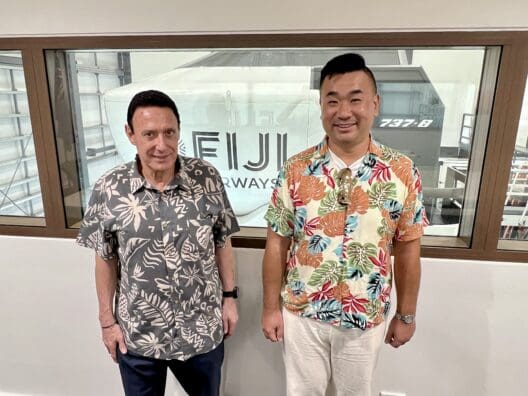 two men standing in front of a window