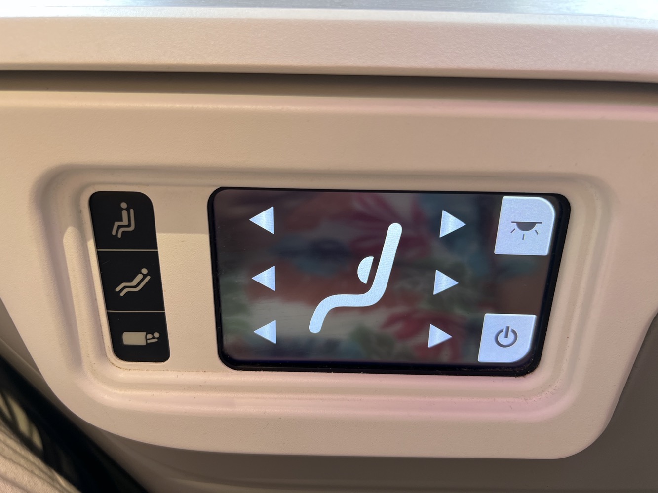 a screen with buttons and buttons on the side of the seat