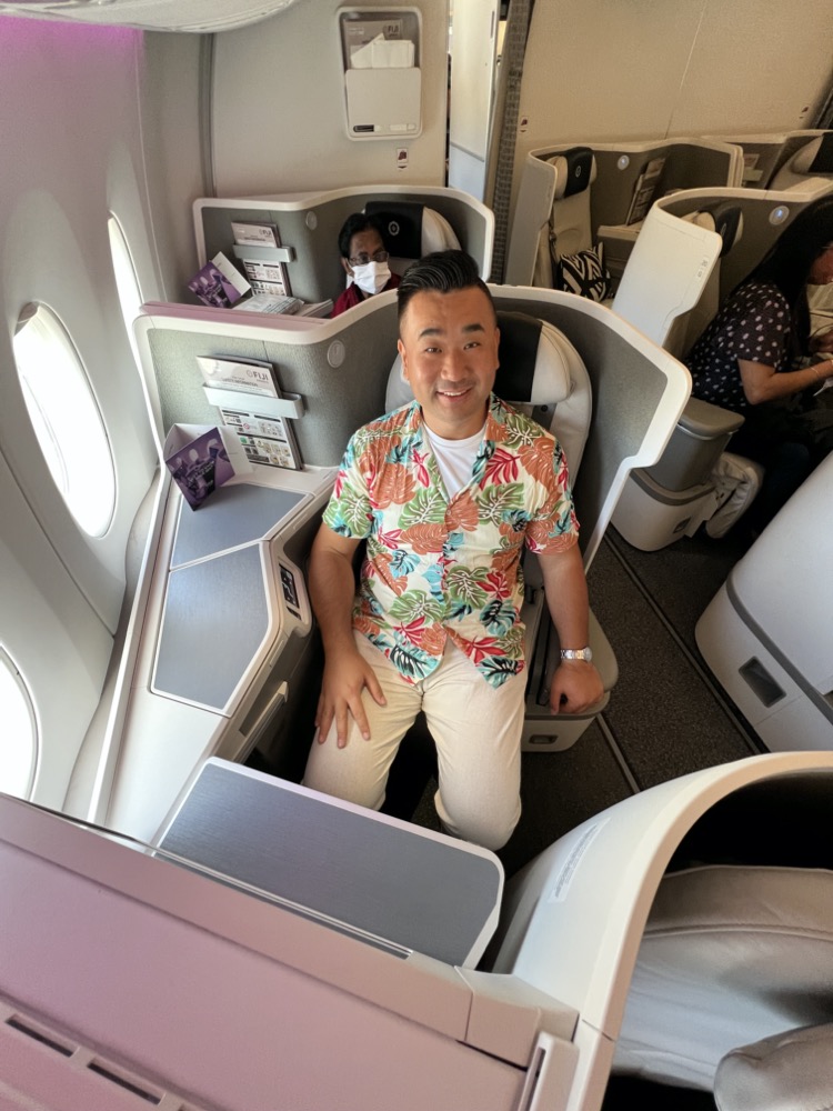 a man sitting in a chair on an airplane