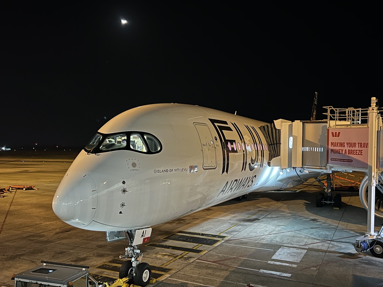 a white airplane on a tarmac at night