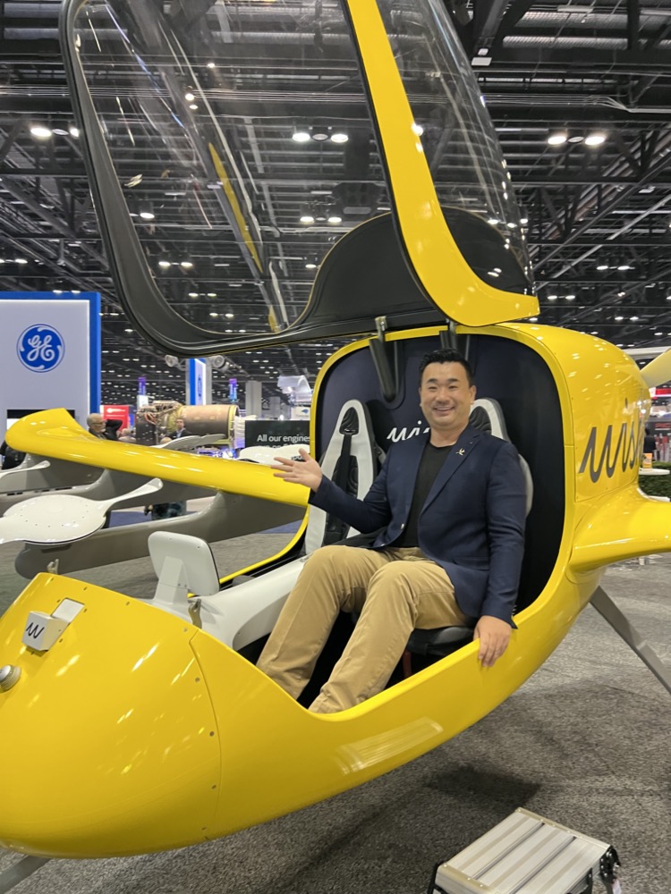 a man sitting in a yellow helicopter