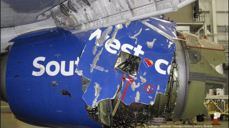 a broken blue sign on a plane