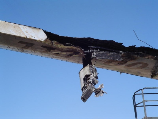 a close-up of a burned out airplane wing