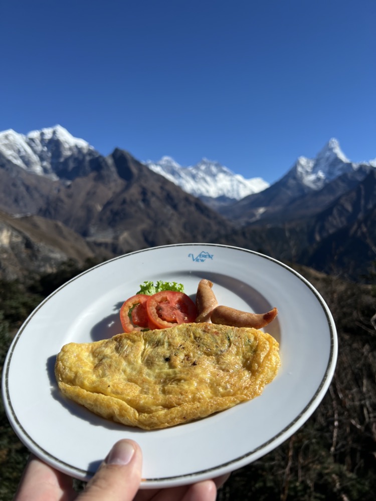 a plate of food with a mountain in the background